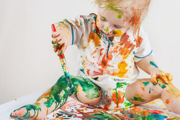 The child messy draws his body. Children's pranks.