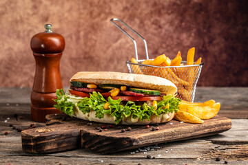 Grilled club sandwich panini with with crispy chicken and salad on cutting board. Turkish chicken doner sandwich. Fast food. copy space