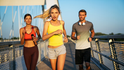 Fitness sport people running lifestyle concept. Group of young people jogging together outdoors.