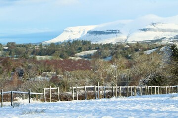 Winter landscape in rural County Sligo, Ireland featuring  snow-covered Benbulben mountain 