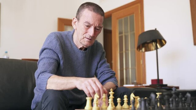 Alzheimer and dementia prevention. Brain training with senior man playing chess