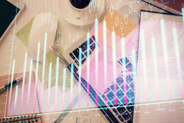 Multi exposure of financial chart drawing over table background with computer. Concept of research and analysis. Top view.