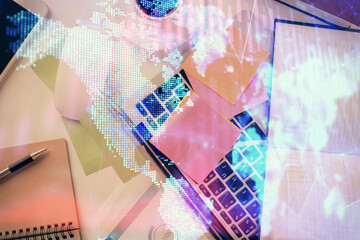 Multi exposure of financial chart drawing over table background with computer. Concept of research and analysis. Top view.