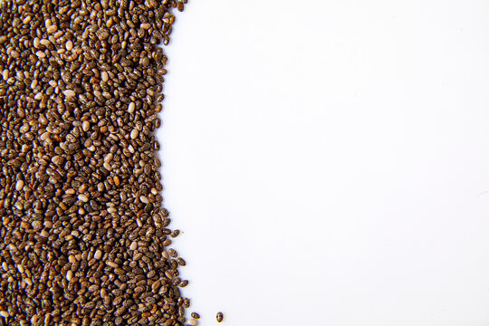 Flat lay macro natural dried Chia seeds, top view, close up texture background © bondarillia