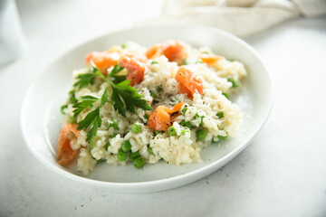 Homemade risotto with salmon and green pea