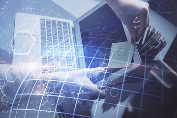 Double exposure of woman hands working on computer and world map hologram drawing. International technology business concept.