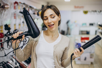 Woman buying hair dryer and straightener
