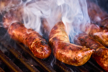 close up with homemade sausages on the grill.