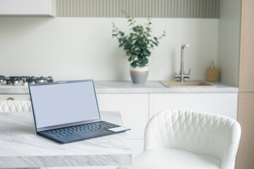Office desk scenery with mockup blank screen laptop computer. Workspace minimal