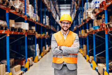 Portrait of happy storage owner proudly standing at storage and smiling at the camera.