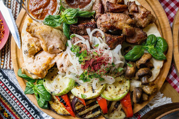 The richly laid table dishes of Georgian cuisine, lots of delicious food,wine,fruits and roasted meat