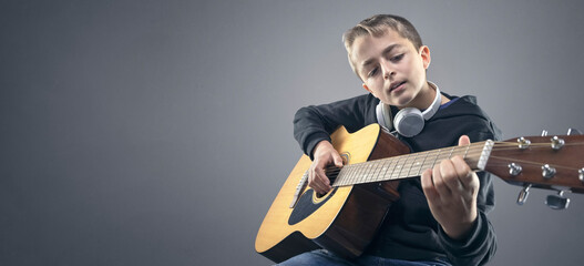 Teenage boy learning to play the acoustic guitar background