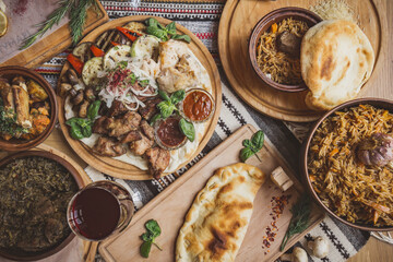 A lot of food on the wooden table. Georgian cuisine. Top view. Flat lay . Khinkali and Georgian dishes
