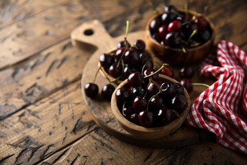 Fresh cherry served in wooden bowls