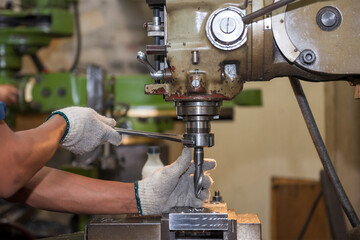 The machine operator change the cutting tool with NC milling machine.