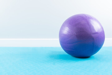 Ball for sports on a blue rug. Horizontal orientation, copy space.
