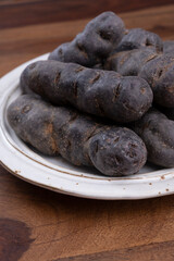 Colorful belgian purple or black truffle potato root vegetable