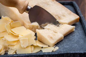 Flakes of parmesan cheese, italian hard parmigiano-reggiano cheese from Reggio Emilia region