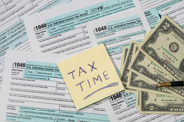 many American tax forms 1040 lie mixed with a piece of paper from a notebook on them