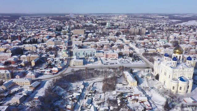  Aerial view of the Ascension Cathedral, located in the historical center of the city on the Red Square of Yelets, and the surrounding his residential areas in winter, Russia.