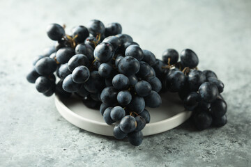 Dark grape on a white plate