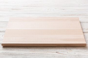 Naklejka na ściany i meble Perspective view of wooden cutting board on wooden background. Empty space for your design