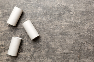 Flat lay composition with empty toilet paper rolls and space for text on color background. Recyclable paper tube with metal plug end made of kraft paper or cardboard