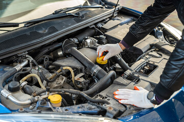 close up of mechanic hand using wrench to service car for repair or check engine