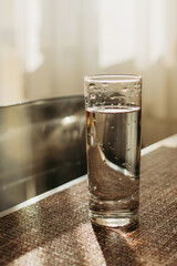 A glass of clean clear water stands on the table