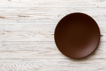 Top view of empty plate on wooden background. Empty space for your design.