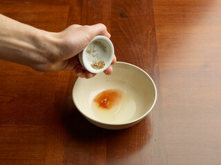 hands putting pepper to make a sauce in the kitchen