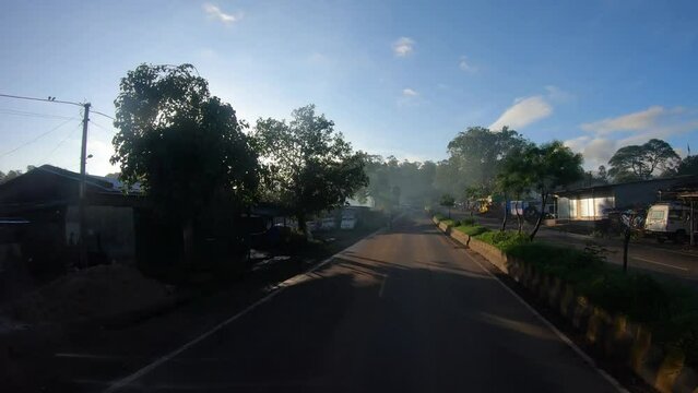 4K POV Hyper lapse of the dashcam of vehicle moving through the village in between the green forests of the Dang district on the way to Saputara in Gujarat, India. 