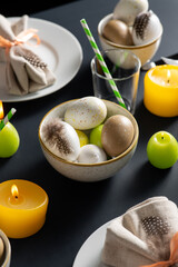 easter, holidays, tradition and object concept - close up of dinner party table serving over black background