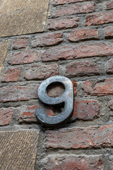 Street house post number 9, nine. Antwerp, Belgium. Street photograph. 