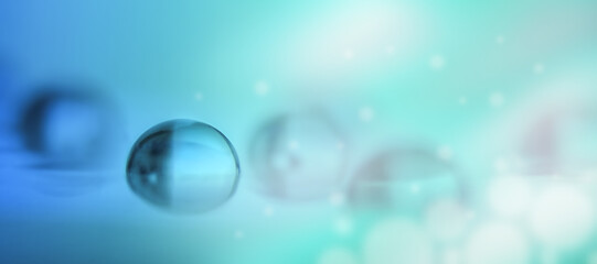 Transparent water drop in blue and green tones in macro.