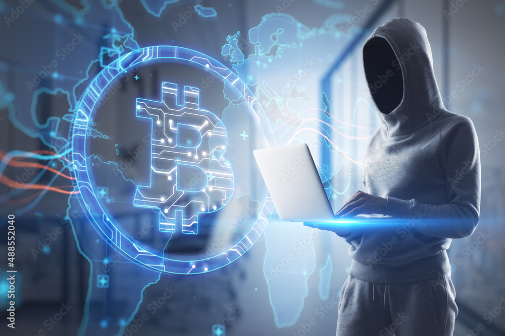 Poster hacker using laptop with creative glowing global bitcoin hologram on blurry office interior backgrou