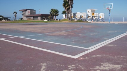 Palm trees and basketball sport field or court on beach, California coast, USA. Streetball...