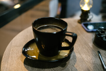 Black coffee cup, a hot beverage in a cafe and black coffee in a cup on the table, selective focus on coffee in cup