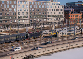 Panorama,  railway, central station, turn points, catenary, electric poles and tunnels. Train, office, station, hotel buildings. Icy canal Karlbergskanalen, in Stockholm