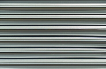 Modern metal fence blinds with shutters texture. Front view metal fence background