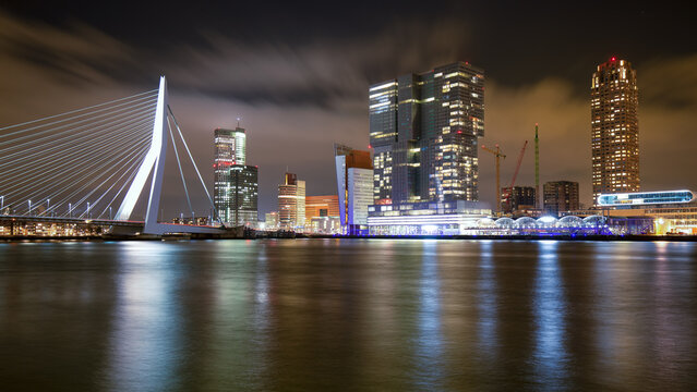 Rotterdam skyline in the night, modern bridge, river, reflection and buildings in Holland, Netherlands.