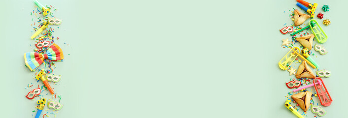 Purim celebration concept (jewish carnival holiday) over green background. Top view, flat lay