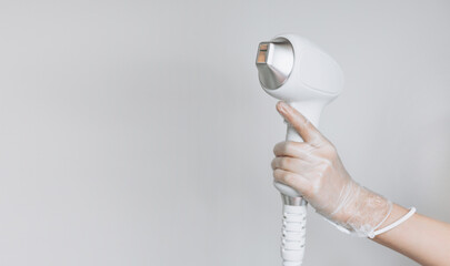 Laser device for removing unwanted hair in the hand of nurse. Laser hair removal, cosmetic body...