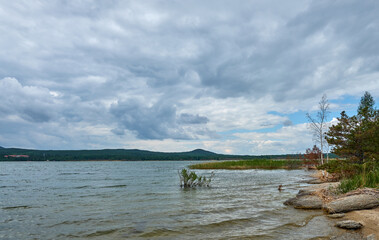 A river with a slow current against the backdrop of a mountain range