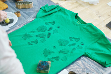 Green T-shirt with printed leaf pattern stamp