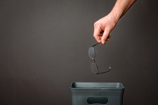 The glasses are thrown into the bucket. Recycling and disposal of secondary raw materials.