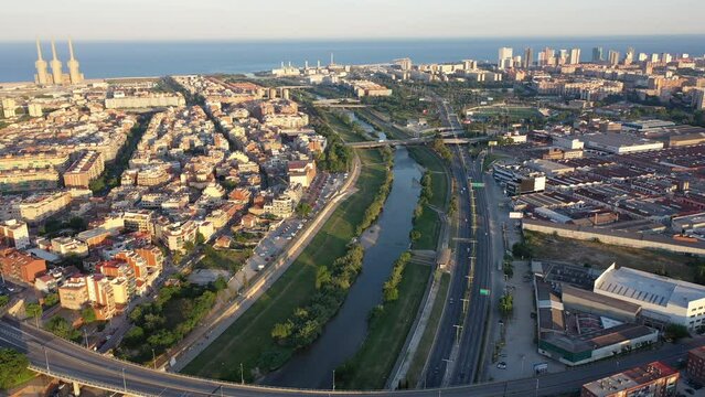 Aerial panoramic view of Sant Adria de Besos and Barcelona on Besos river with Mediterranean sea in background on sunny day, Spain