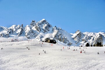 Snowcapped mountain with skiers in winter 