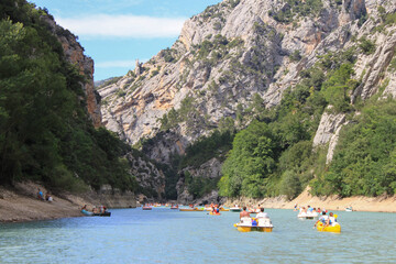 People in boats or pedal boats discover the beautiful french Canyon Gorge du Verdon, Provence,...