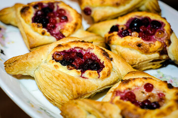 Fresh homemade pastry with curd and frozen berries filling. Selective focus
